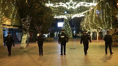 Police officers walking while patrolling empty boulevard