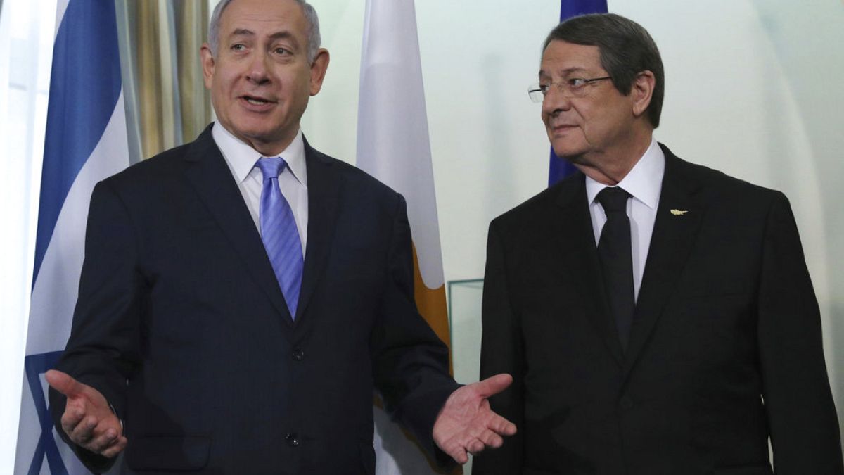 Cyprus' president Nikos Anastasiades, left, talks with Israeli Prime Minister Benjamin Netanyahu