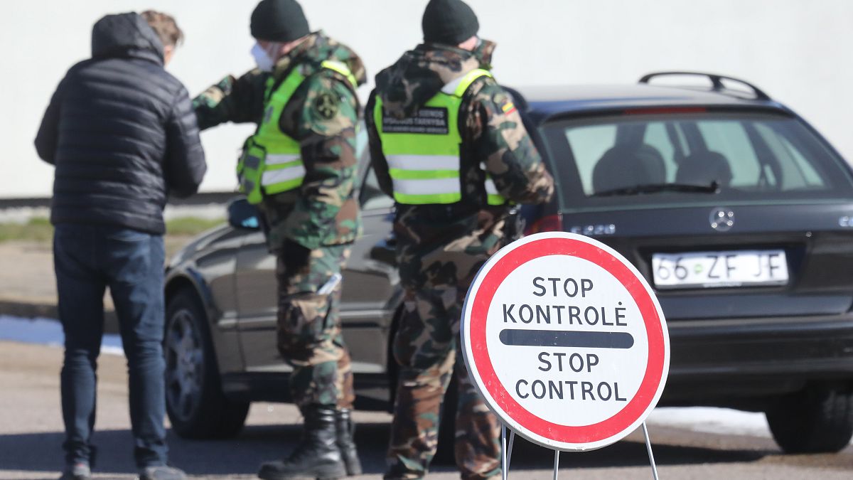 Lithuanian police check a driver at Kalvarija-Budzisko border crossing with Poland on March 15, 2020, before frontiers were closed during the first coronavirus wave.