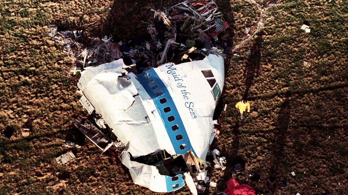 FILE - In this Dec. 22, 1988, file photo police and investigators look at what remains of the nose of Pan Am 103 in a field in Lockerbie, Scotland.