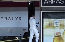 A member of the police forensics team takes part in an investigation next to a Thalys train on the platform at Arras train station, northern France, on Aug.22, 2015