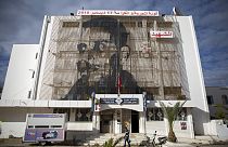 Mohammed Bouazizi is depicted on the facade of post office in Sidi Bouzid, Tunisia, on Friday Dec.11, 2020.