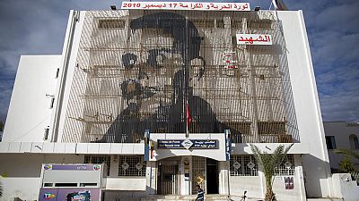 Mohammed Bouazizi is depicted on the facade of post office in Sidi Bouzid, Tunisia, on Friday Dec.11, 2020.