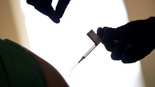 FILE - In this Dec. 15, 2020 photo, a droplet falls from a syringe after a health care worker was injected with the Pfizer-BioNTech COVID-19 vaccine.