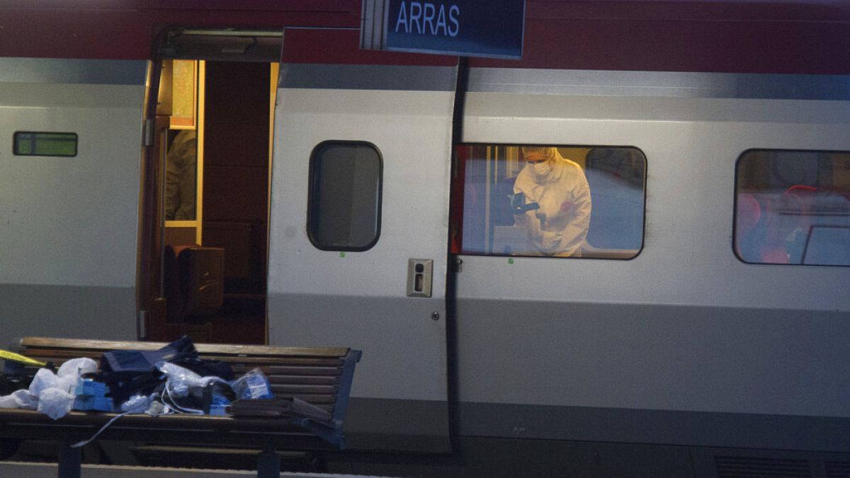 A police officer videos the crime scene inside a Thalys train at Arras train station, after a gunman opened fire with an automatic weapon