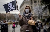 People protest against a law to legalize euthanasia in front of the Spanish Parliament in Madrid, Spain, Thursday, Dec. 17, 2020.