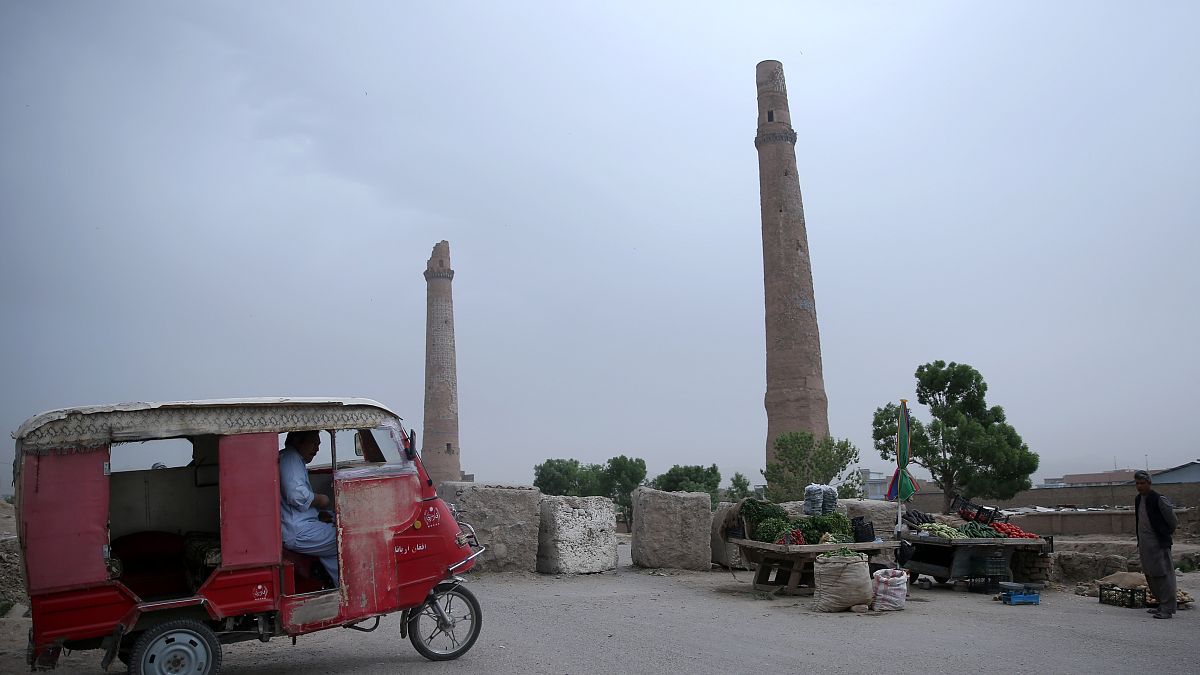 An Afghan rickshaw driver, left, waits for customers near the historical minarets in the center of Herat city, west of capital Kabul, Afghanistan, Tuesday, April 14, 2015.