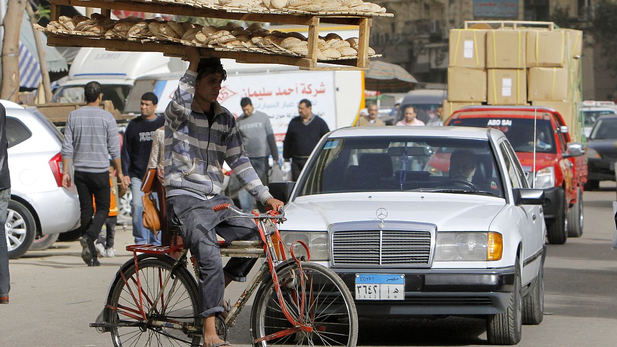 March 16, 2013 file photo, an Egyptian bread vendor rides his bicycle in downtown Cairo, Egypt