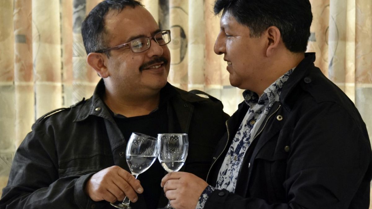 David Aruquipa (L) and Guido Montano make a toast during a press conference after their same-sex union was oficially recognised by the state following a long legal battle in L