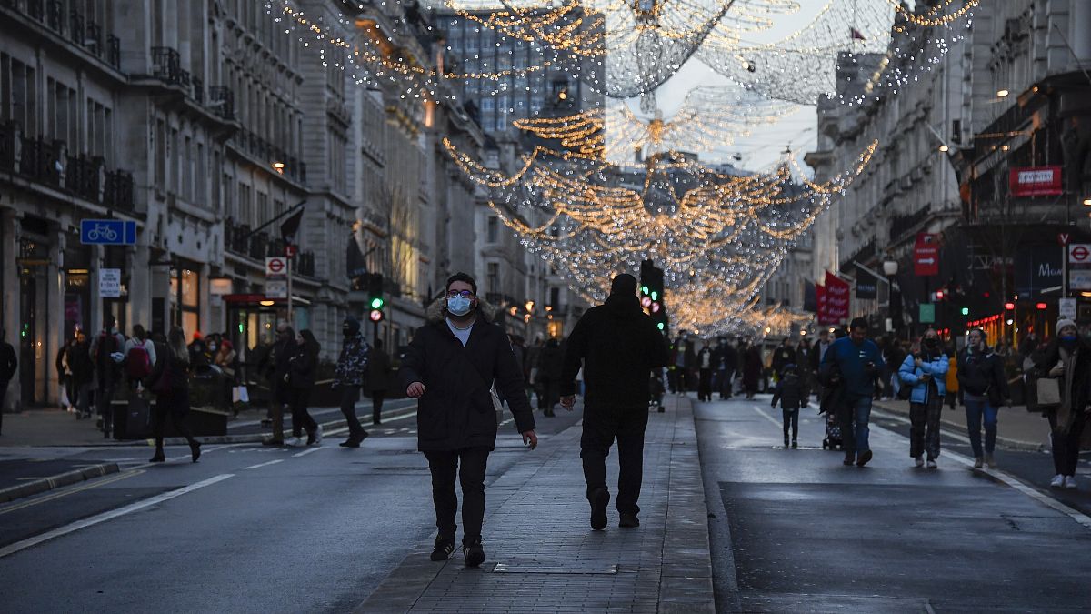 A man wears a face mask while he walks in Regent Street, ahead of the new Tier-4 restriction measures.