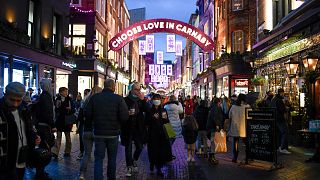 Shoppers wear face masks as they walk in Carnaby Street