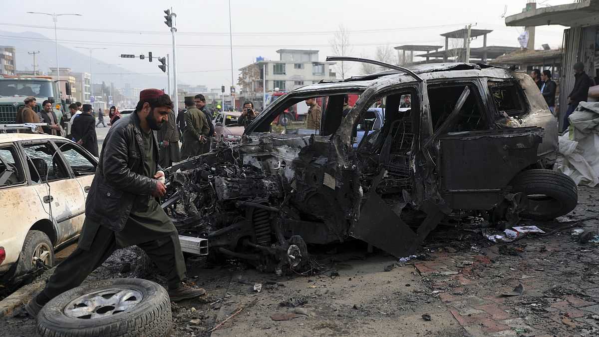 People gather near the site of a deadly bombing attack in Kabul, Afghanistan, Sunday, Dec. 20, 2020.