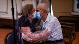 Agustina Cañamero, 81, and Pascual Pérez, 84, hug and kiss through a plastic film screen to avoid contracting the new coronavirus at a nursing home in Spain. June 22, 2020