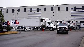 A FedEx truck loaded with boxes containing the Moderna COVID-19 vaccine leaves the McKesson distribution center in Olive Branch, Miss., 