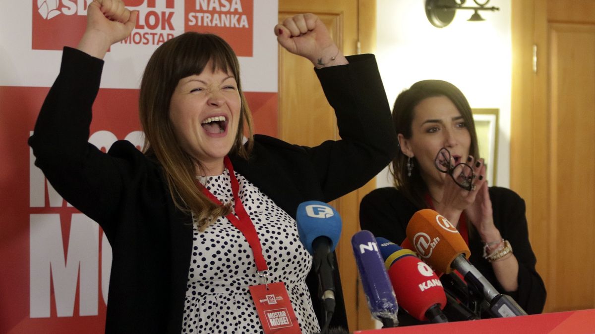 Irma Baralija greets supporters in her headquarters after local election in Mostar, Bosnia, Sunday, Dec. 20, 2020.