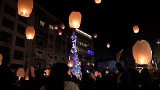 Lanterns launched into the sky during the lighting of a Christmas tree in memory of the victims of the devastating Port of Beirut explosion in August