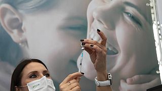 An Israeli nurse prepares a COVID-19 vaccine at a temporary vaccination center in the lobby of a gymnasium in Tel Aviv