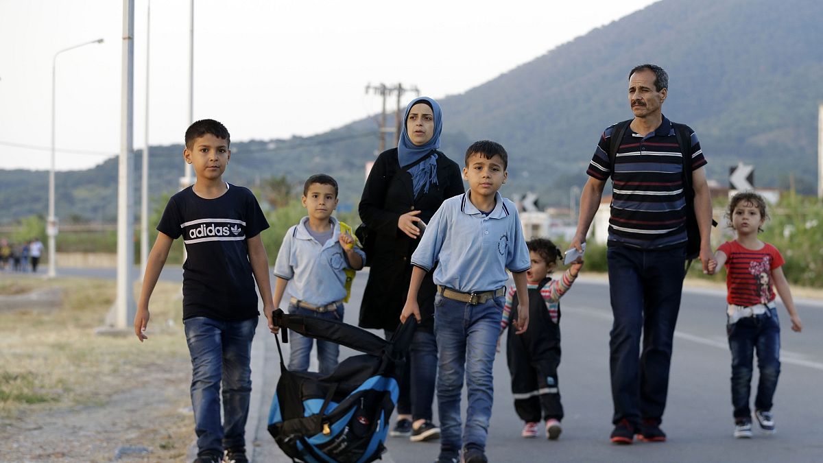 A Syrian family head to Mytilene to be counted by Greek authorities