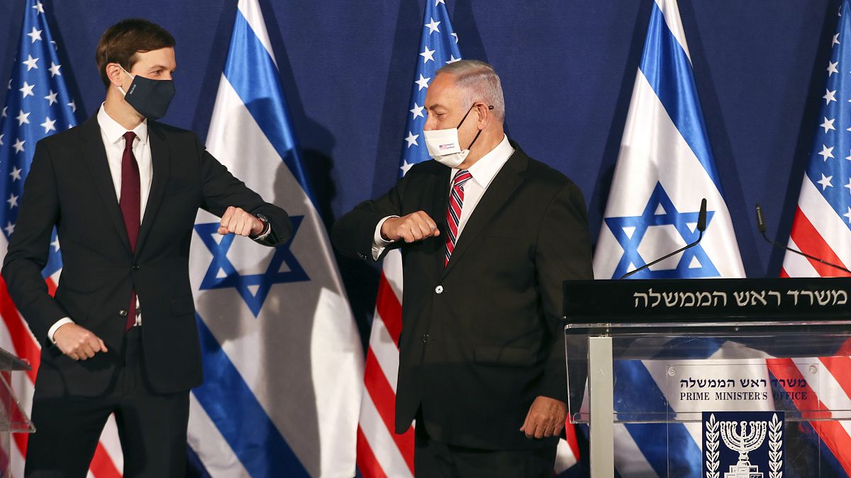 White House senior adviser Jared Kushner, left, elbow bumps Israeli Prime Minister Benjamin Netanyahu 