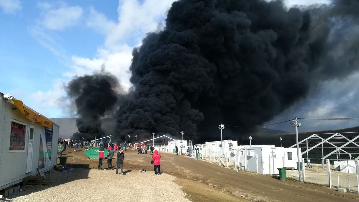 Smoke rises from a fire at migrant camp Lipa, Wednesday, Dec 23, 2020, near Bihac in western Bosnia.