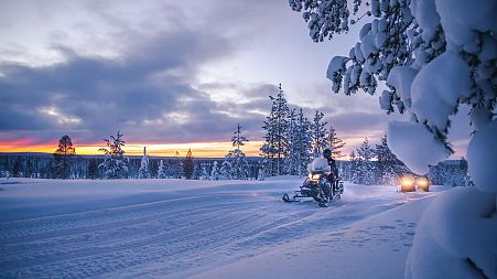 Sunrise safari by electric snowmobiles