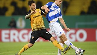 Dynamo's Philipp Hosiner, left, with Darmstadt's Lars Lukas Mai, during their German Bundesliga 2nd round match at the Rudolf-Harbig-Stadion in Dresden, Dec 22, 2020.