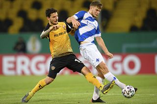 Dynamo's Philipp Hosiner, left, with Darmstadt's Lars Lukas Mai, during their German Bundesliga 2nd round match at the Rudolf-Harbig-Stadion in Dresden, Dec 22, 2020.