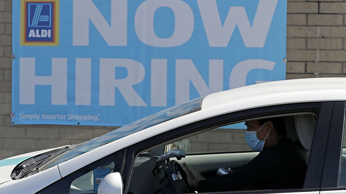 This May 8, 2020 photo shows a hiring sign at the Aldi grocery store in Morton Grove, Ill.