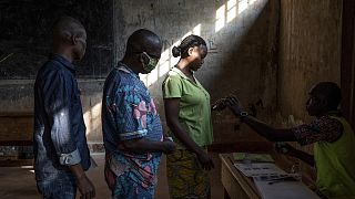 People cast their votes for presidential and legislative elections, at the Lycee Boganda polling station in the capital Bangui, Central African Republic Sunday, Dec. 27, 2020.