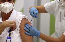 A hospital staff receives an injection with a dose of COVID-19 vaccine in Vienna, Austria