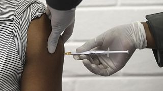 a volunteer receives an injection in Johannesburg as part of Africa's first participation in a COVID-19 vaccine trial developed by Oxford University and AstraZeneca.