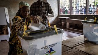 A woman casts her vote after polls opened for presidential and legislative elections in the capital Bangui, Central African Republic.