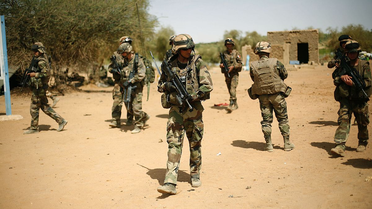 FILE-- In this photo taken Sunday Feb. 10, 2013, French soldiers secure the area where a suicide bomber exploded at the entrance of Gao, northern Mali.
