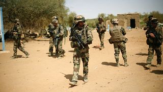 FILE-- In this photo taken Sunday Feb. 10, 2013, French soldiers secure the area where a suicide bomber exploded at the entrance of Gao, northern Mali.