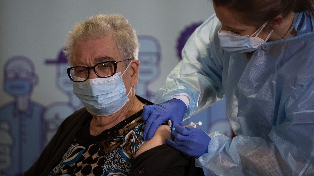 Josefa Perez, 89, is vaccinated against the Corona virus at a nursing home in l'Hospitalet de Llobregat in Barcelona, Spain, on Sunday, Dec. 27, 2020.