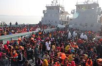 Rohingya refugees settle on to naval ships to be transported to an isolated island in the Bay of Bengal, in Chittagong, Bangladesh, Tuesday, Dec. 29, 2020.