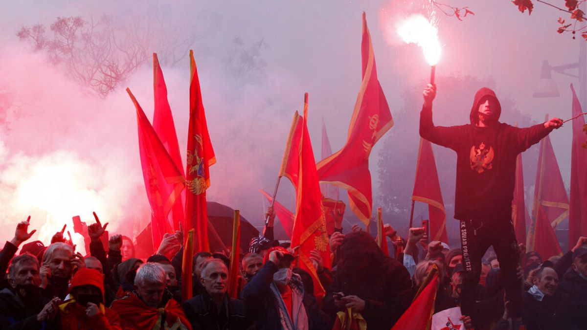 People shout slogans during a protest against the new government in Podgorica, Montenegro, Monday, Dec. 28, 2020.