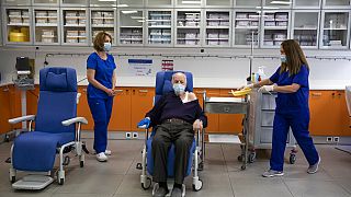 Michalis Giovanidis, a nursing home resident, waits to receive an injection with a dose of COVID-19 vaccine, in Athens