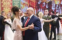 Alexander Lukashenko pictured dancing with a young woman at the ball.