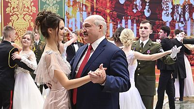 Alexander Lukashenko pictured dancing with a young woman at the ball.