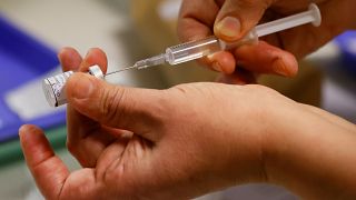 A health worker extracts a dose of the Pfizer-BioNTech Covid-19 vaccine at the Rene-Muret hospital in Servan near Paris, Sunday Dec. 27, 2020.