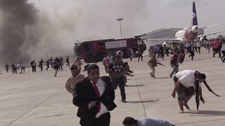 People run following an explosion at the airport in Aden, Yemen, shortly after a plane carrying the newly formed Cabinet landed on Wednesday, Dec. 30, 2020.