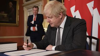 Boris Johnson signs the EU-UK Trade and Cooperation Agreement at 10 Downing Street, London Wednesday Dec. 30, 2020.