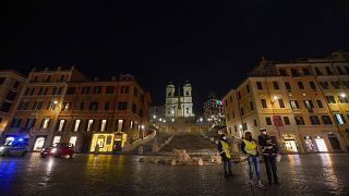 Police officers patrol an empty Spanish Steps square, usually a popular spot for New Year's Eve celebrations, in Rome