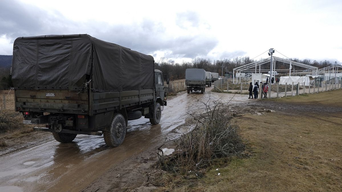 Bosnian soldiers arrive at the Lipa refugee camp outside Bihac, to erect tents for some hundreds of migrants who have been stuck in a burnt out camp.