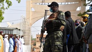 A Nigerien soldier stands guard as Niger's outgoing president Mahamadou Issoufou arrives at a polling stating in Niamey on December 27, 2020.