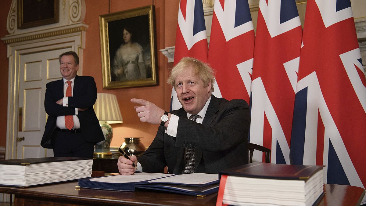 Prime Minister Boris Johnson signs the EU-UK Trade and Cooperation Agreement at 10 Downing Street, London Wednesday Dec. 30, 2020. 