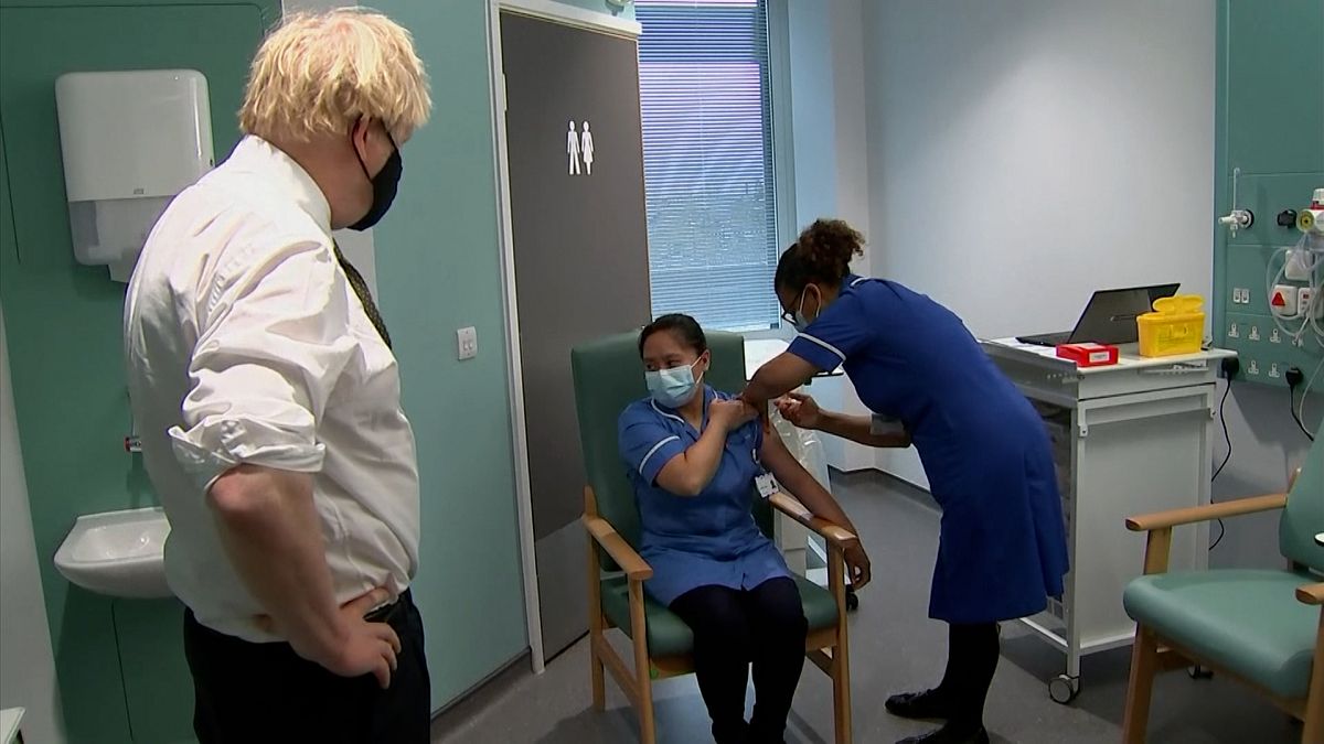 British prime minister Boris Johnson watching nurse receiving vaccine
