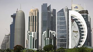 In this May 5, 2018 photo, a giant image of the Emir of Qatar Sheikh Tamim bin Hamad Al Thani, adorns a tower in Doha, Qatar. 