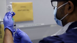 Senior Clinical Research Nurse Ajithkumar Sukumaran prepares the COVID 19 vaccine to administer to a volunteer, at a clinic in London, Wednesday, Aug. 5, 2020.